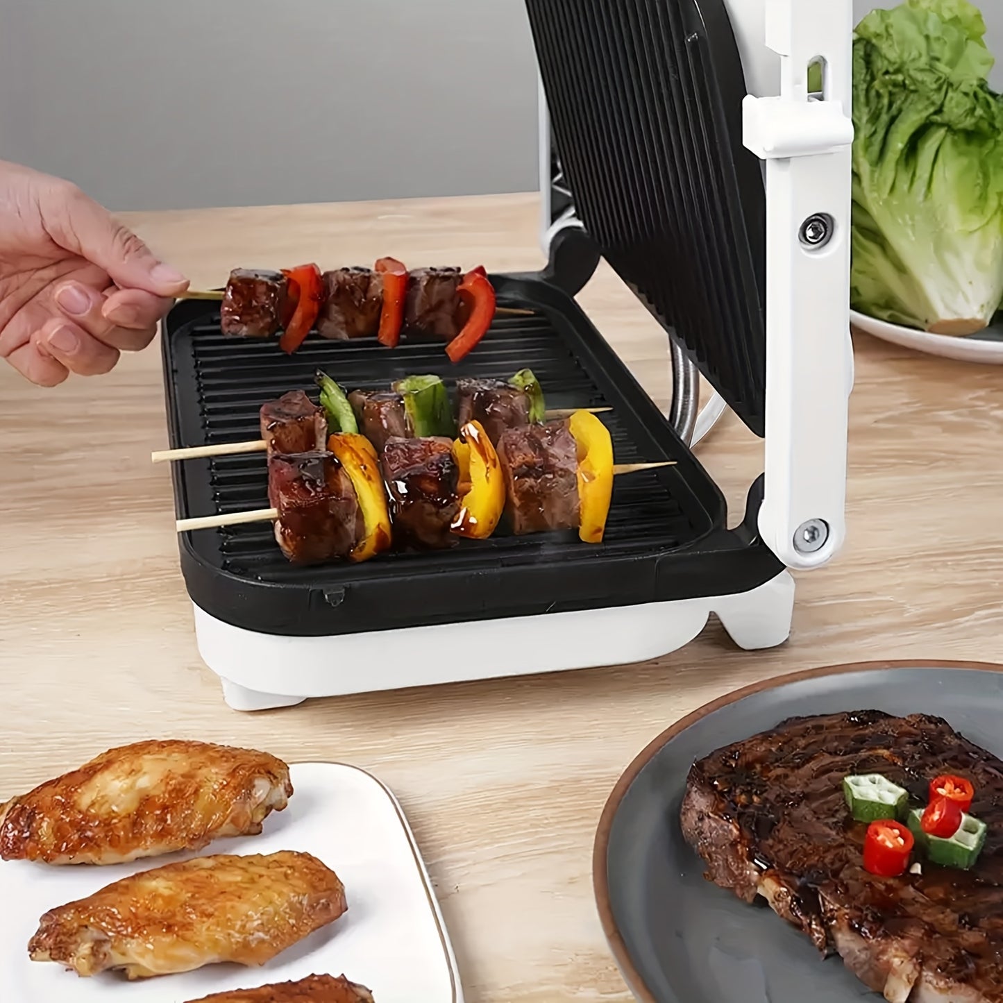 Single electric indoor grill with nonstick grids, locking lid, and 1100-1300W power for various dishes