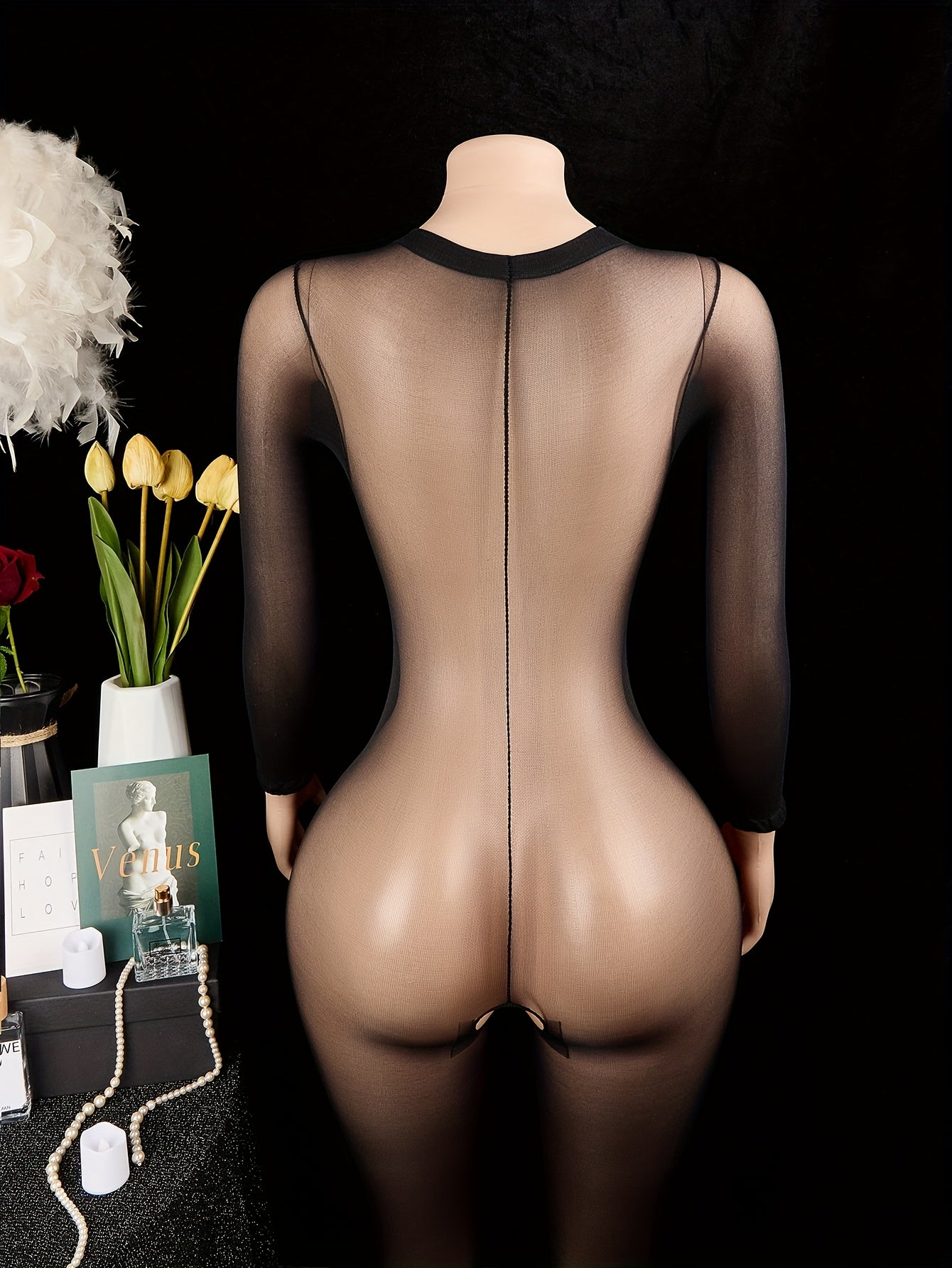 Sleek women's bodysuit with open crotch, hollow-out detail, long sleeves, high stretch, and see-through design.