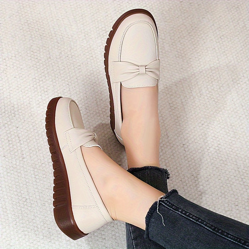 Women's comfortable penny loafers with bow embellishment, non-slip sole, round toe, all-season footwear, man-made materials, TPR sole.