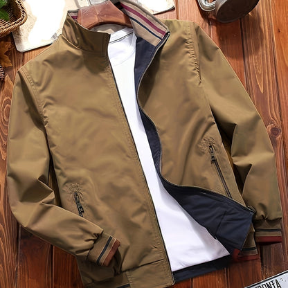 Men's olive green casual jacket with dual-sided design, pockets, stand collar, and striped cuffs. Ideal for spring/fall and travel. Zipper closure.