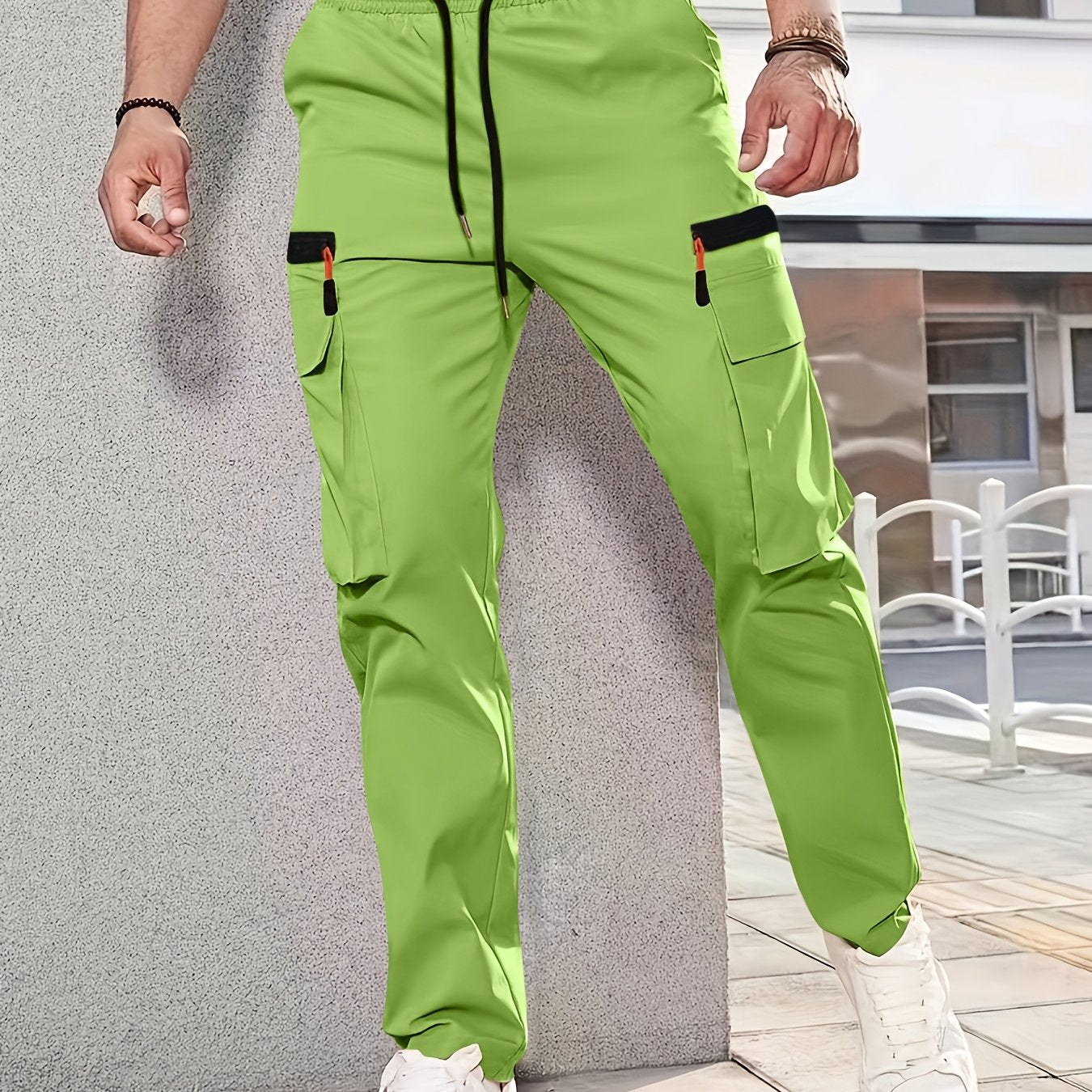 Men's casual cargo pants made of solid color polyester, feature a regular fit, multiple pockets, and straight-leg design for sports and leisure activities all year round.