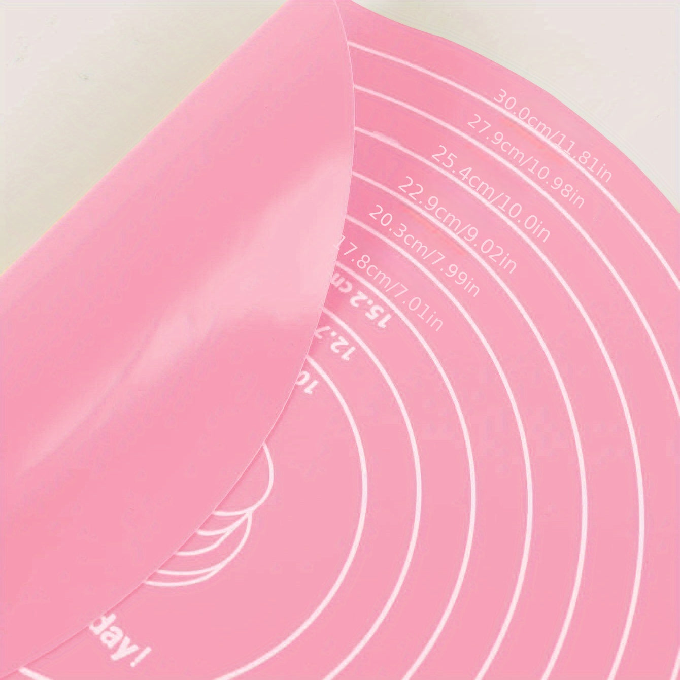 Silicone baking mat with measurements for cake turntable stand, non-stick and heat resistant. Perfect for pastry baking.