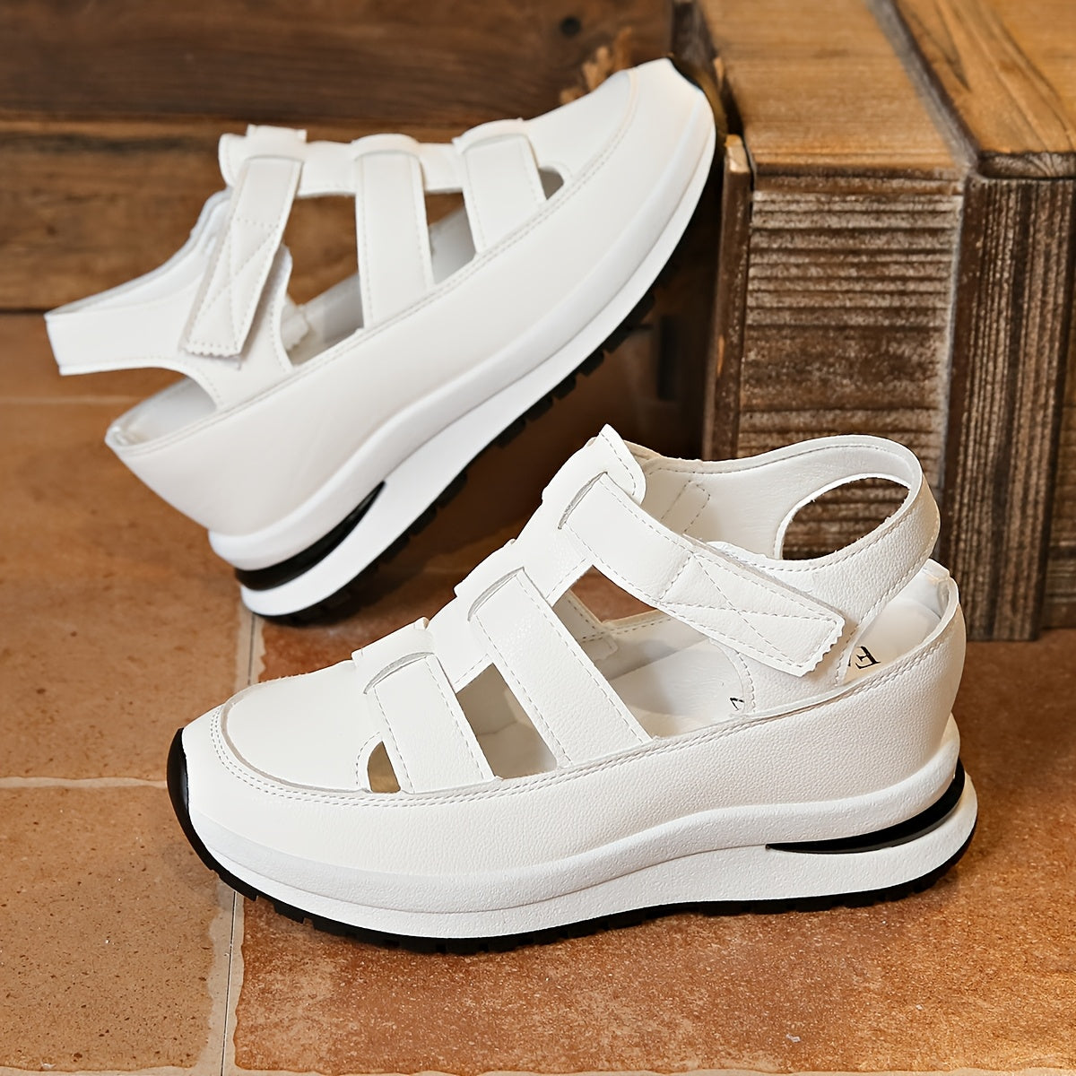 Stylish summer wedge sandals for women with breathable fastener closure and soft sole. White faux cover for casual comfort outdoors or on vacation. Chic wedge design in synthetic material.