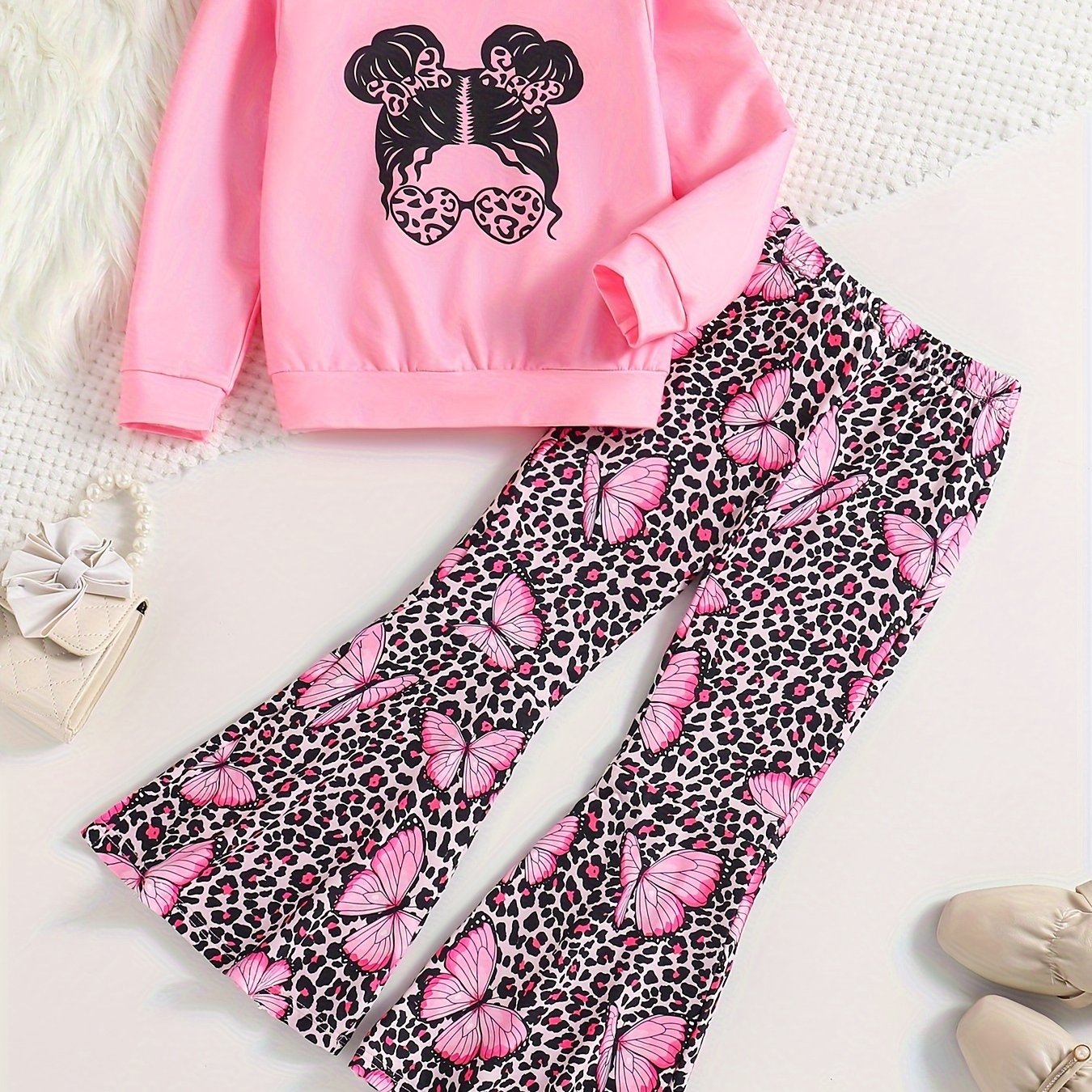 Girls' trendy 2-piece outfit includes a sweatshirt, leopard pattern flared pants, and sunglasses print. Perfect for spring and fall outdoor wear.