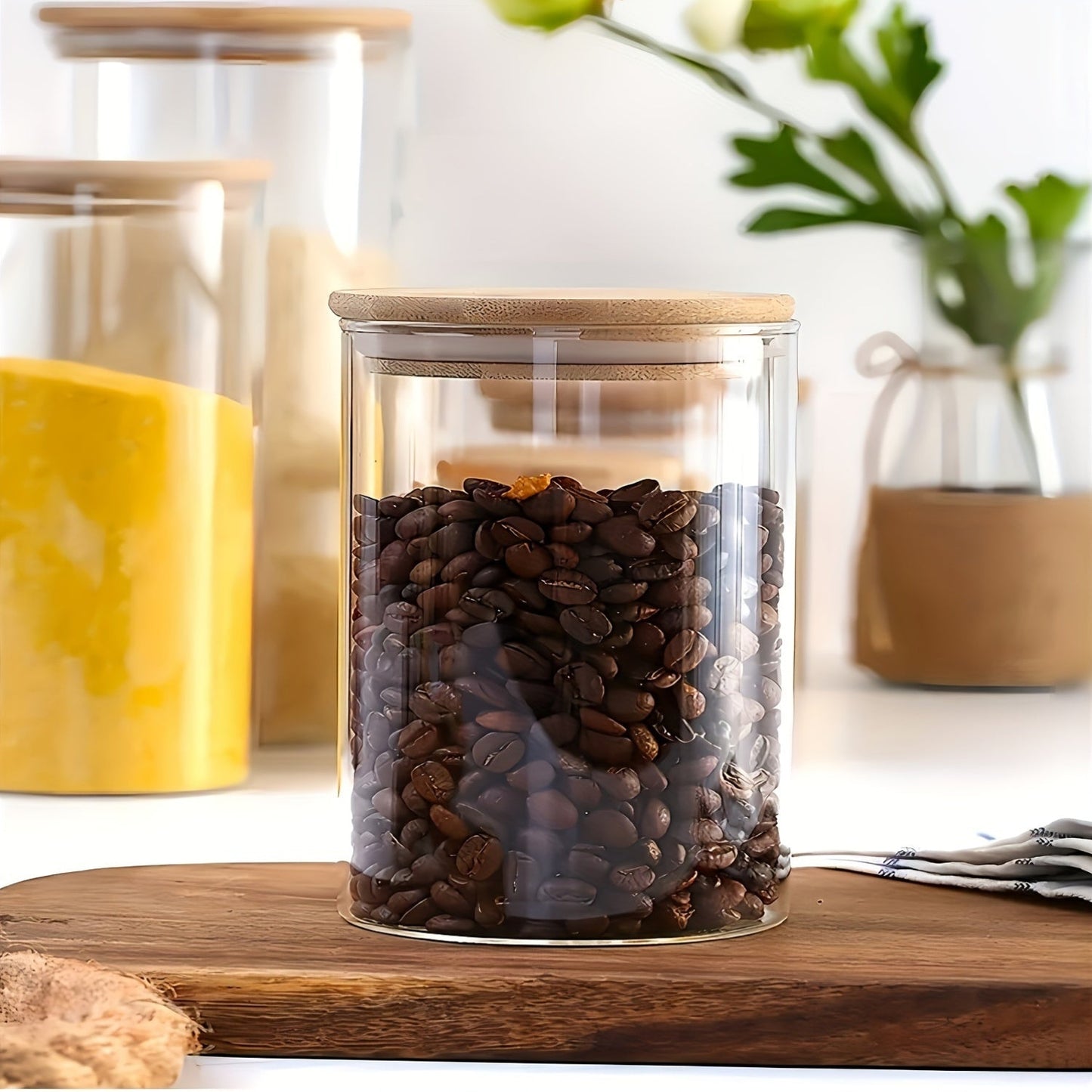 Set of 5 glass food storage jars with bamboo lids, perfect for storing dry goods such as pasta, tea, and nuts. These airtight kitchen canisters are made from high borosilicate glass with a large capacity. No electricity is needed to use these food-safe