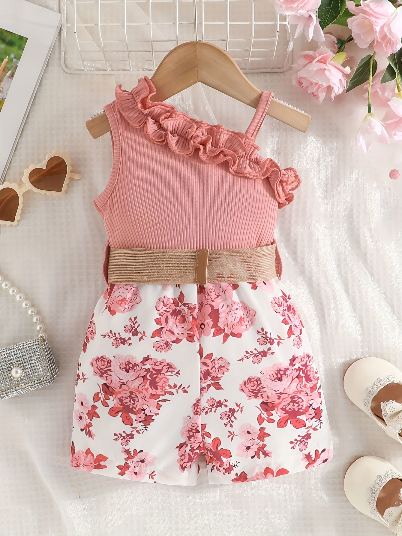 Infant girl's one-shoulder romper with belt in flower pattern for summer outings.