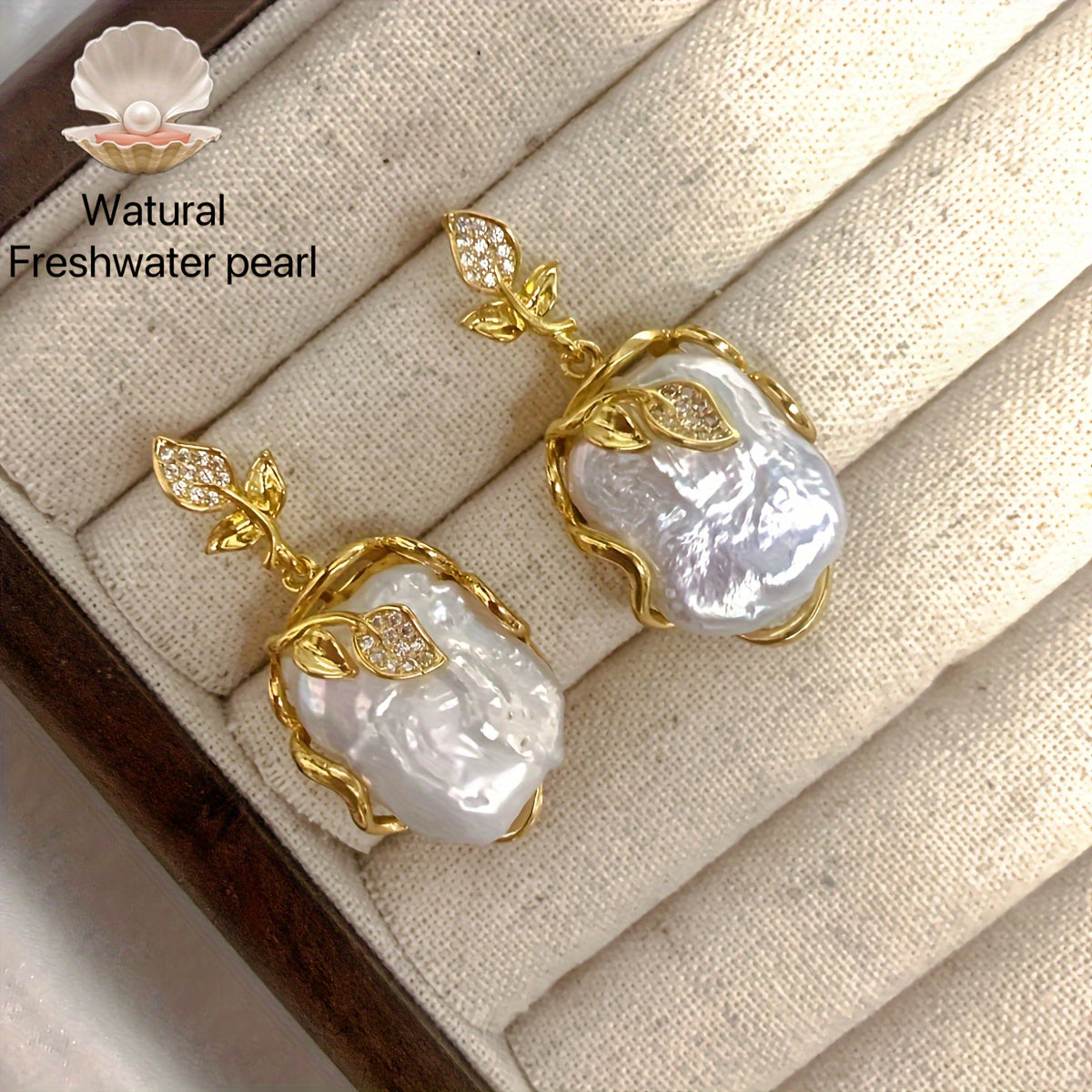 Elegant and luxurious French-inspired freshwater pearl earrings with gold-plated silver leaf accents, perfect for fashion-forward women with a taste for retro style and natural beauty.