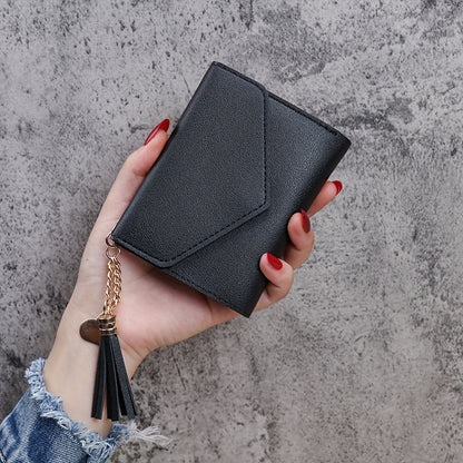 Compact trifold wallet for women with faux clutch coin purse, minimalist credit card holder, stylish tassel charm, and versatile for daily use.