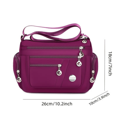 Women's versatile crossbody bag with adjustable strap, multiple compartments, zipper closure, and polyester lining for shopping, office, and travel, available in multiple colors.