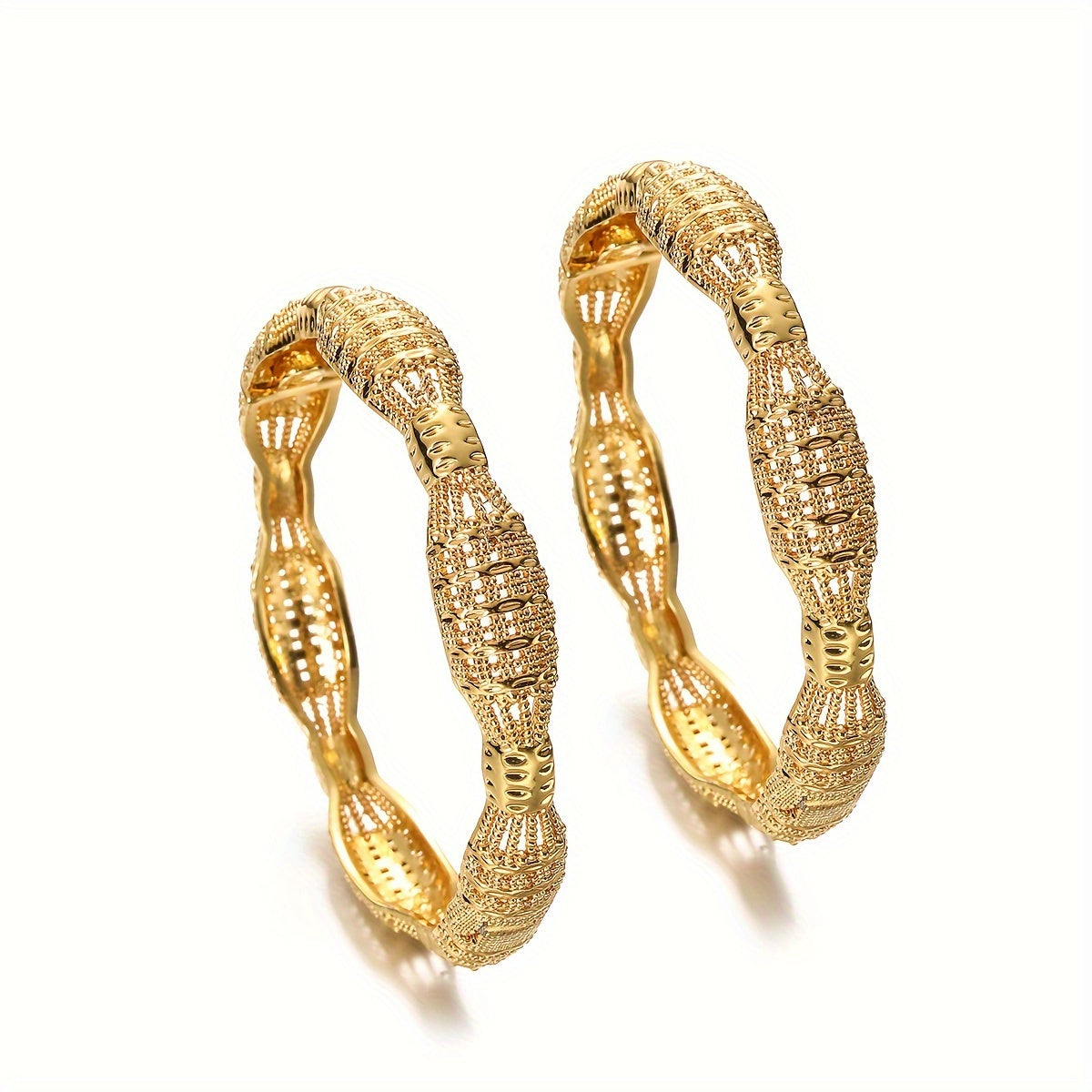 Vintage and sexy, this set of two golden Ethiopian bangle bracelets is perfect for women. Made of alloy, they are ideal for both casual attire and special occasions.