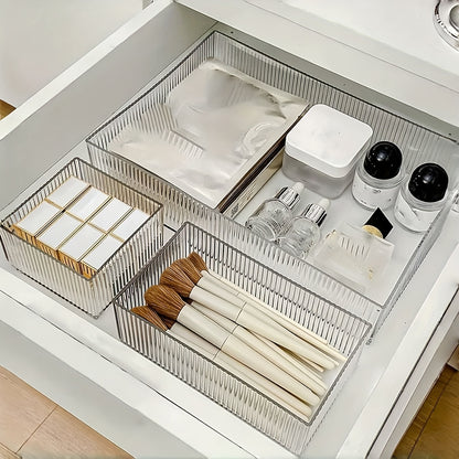 Clear plastic organizer set with customizable drawers for cosmetics and various storage needs, suitable for multiple spaces.