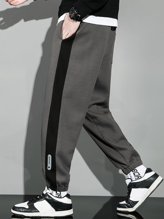 Men's casual joggers with contrast side stripe, elastic waist drawstring, regular fit tapered leg for leisure.