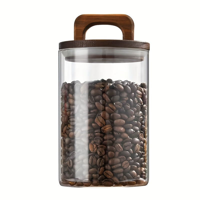 Glass storage jar with a wooden lid and a capacity of 27oz/800mL. This multi-purpose jar is freezer safe and should be hand washed only. Perfect for storing coffee, tea, or food.