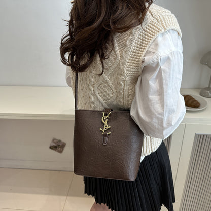 Elegant women's crossbody bucket bag with vintage style, adjustable strap, zipper closure, polyester lined. Available in black, white, dark brown, light brown. Suitable for work, commute