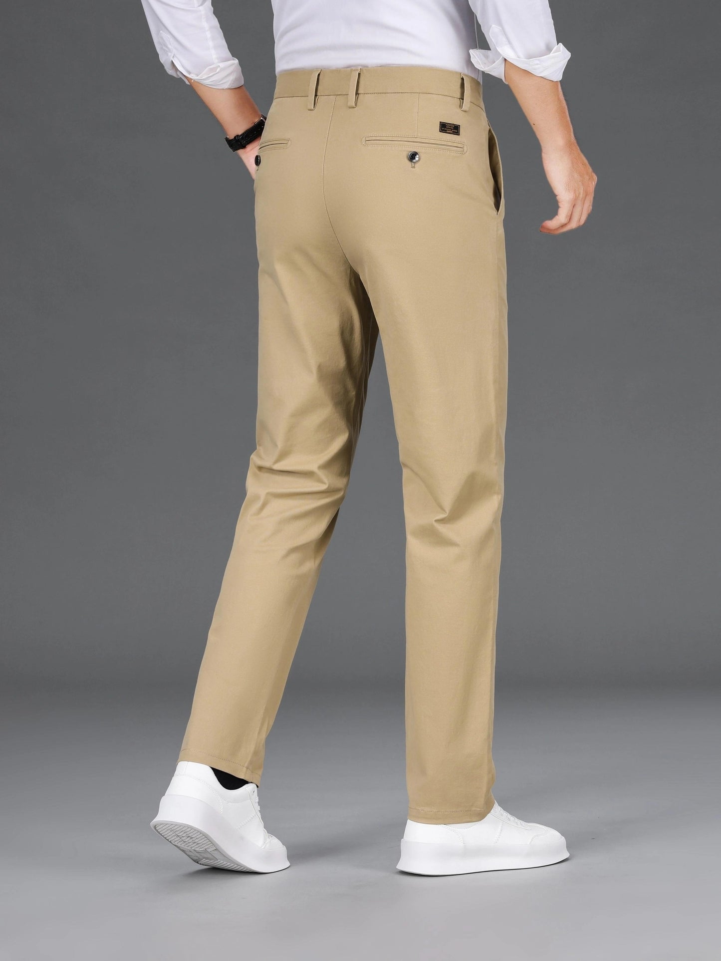 Men's slim-fit cotton blend trousers in solid color, suitable for business casual wear throughout the year. Features micro-elastic fabric, pockets, and regular length.