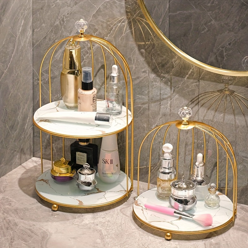 Elegant golden and white marble birdcage-inspired 2-tier makeup organizer with stainless steel rack and electrostatic spray finish. Portable and freestanding for bathroom and bedroom decor.