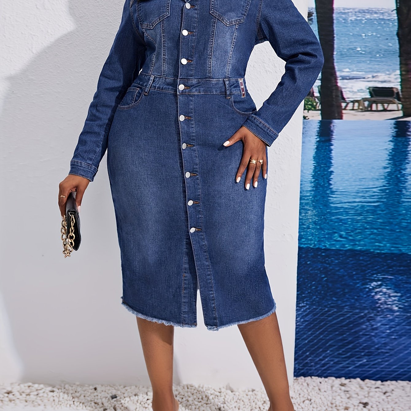 Kiki Angel offers a plus-size denim midi dress with a button-front, lapel collar, and frayed hem. Made from a cotton blend fabric, this solid color tunic is perfect for casual style in