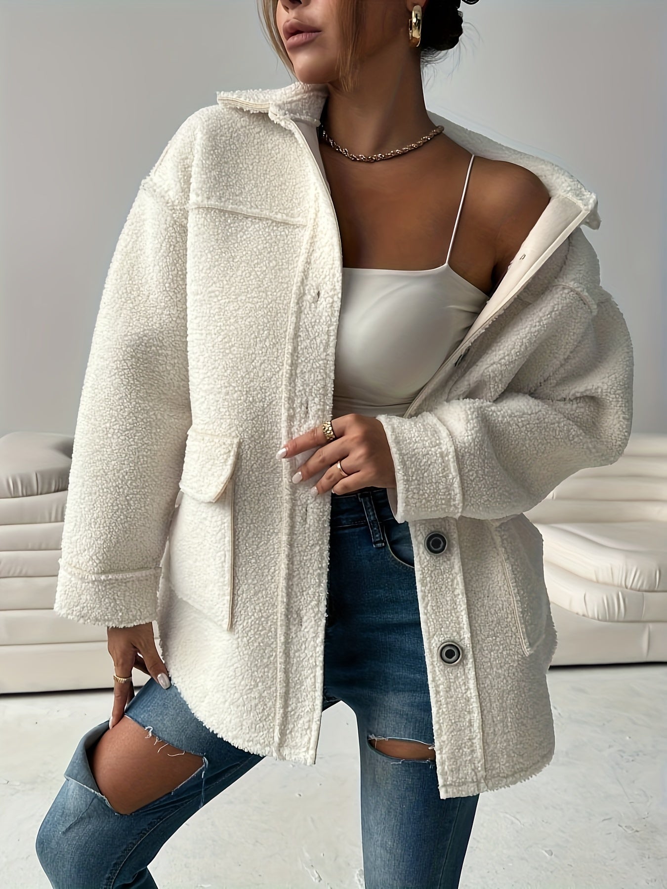 Women's casual teddy jacket made of solid color polyester knit fabric with lapel collar and button details, perfect for fall/winter.