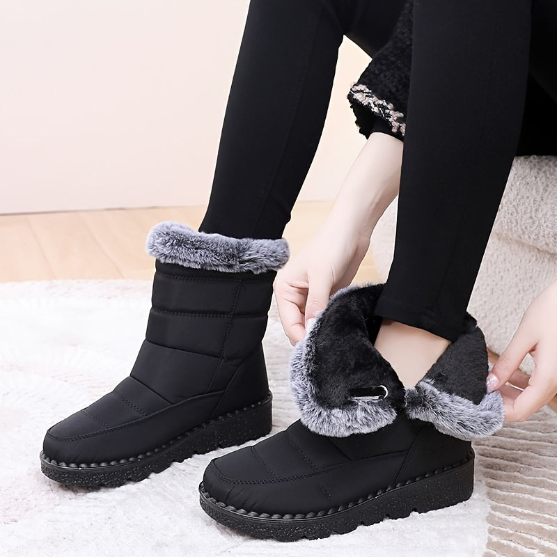 Women's cozy winter snow boots with warm fleece lining, waterproof features, thick traction sole, non-slip, black color. Ideal for outdoor adventures.