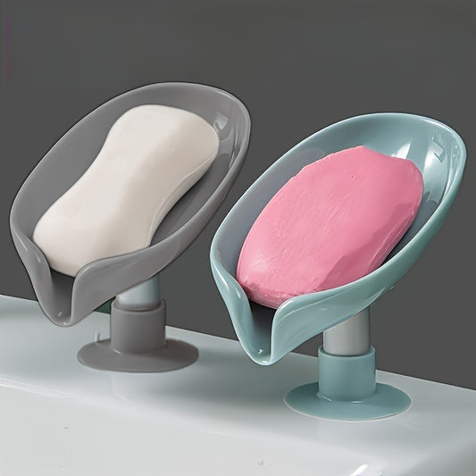 Plastic oval soap dish with suction cup design for home use.