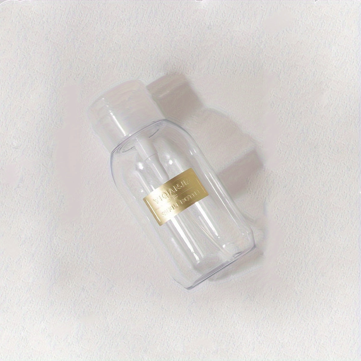 A portable push down empty bottle for dispensing nail polish or makeup remover.