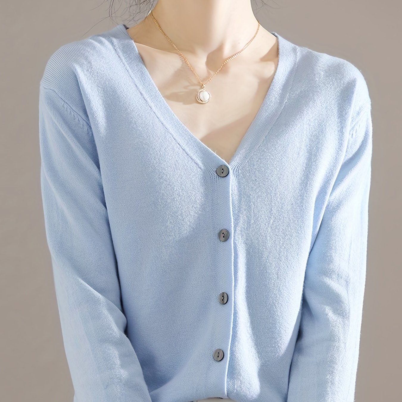 Chic V-neck cardigan with long sleeves, perfect for spring and fall.