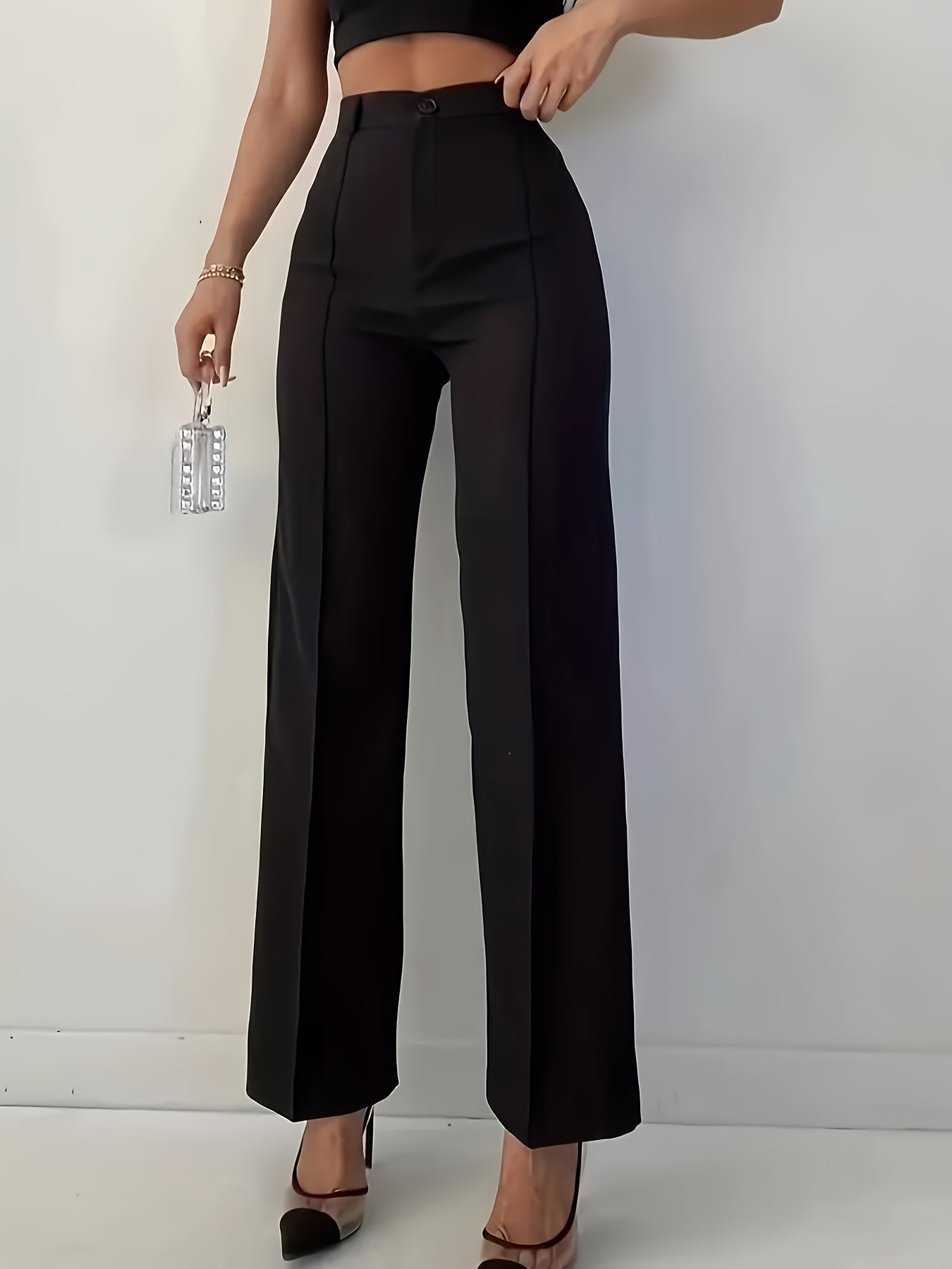 Stylish women's black pants, high-waisted, sleek polyester material, machine washable - suitable for professional and social occasions.