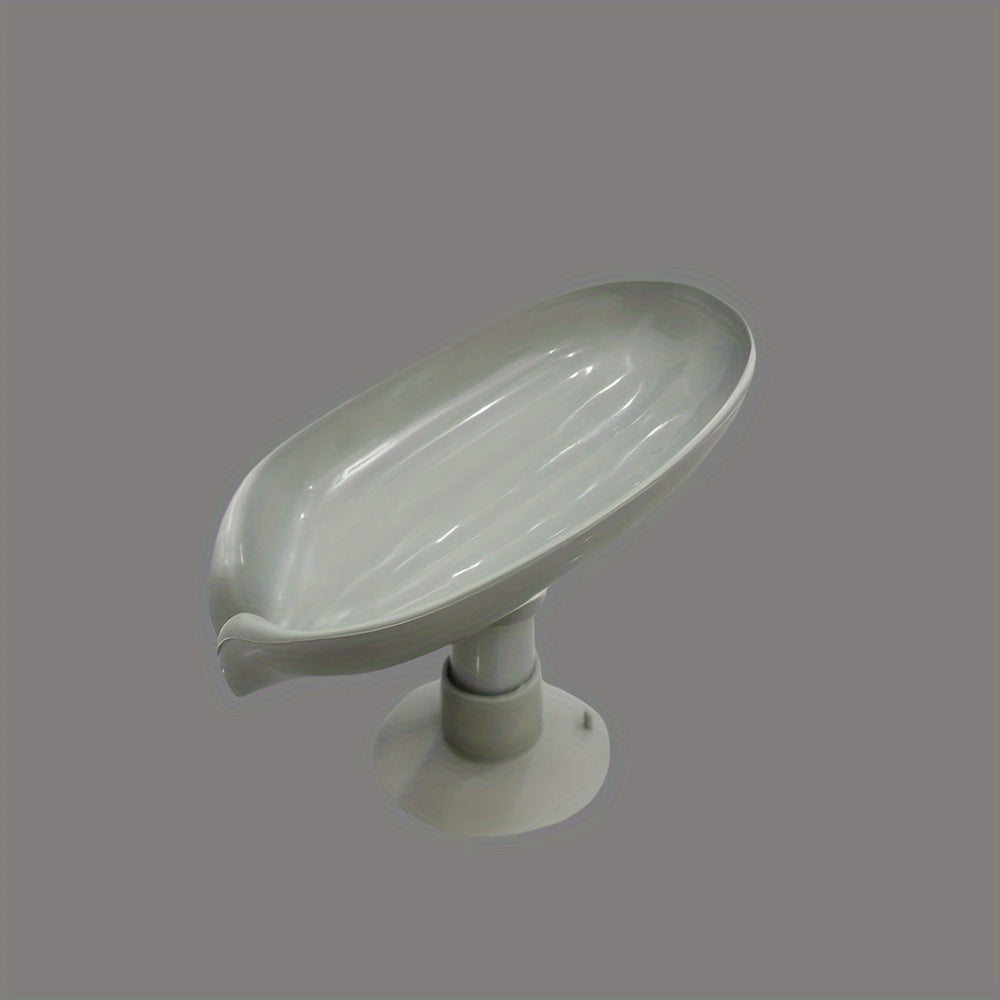 Plastic oval soap dish with suction cup design for home use.