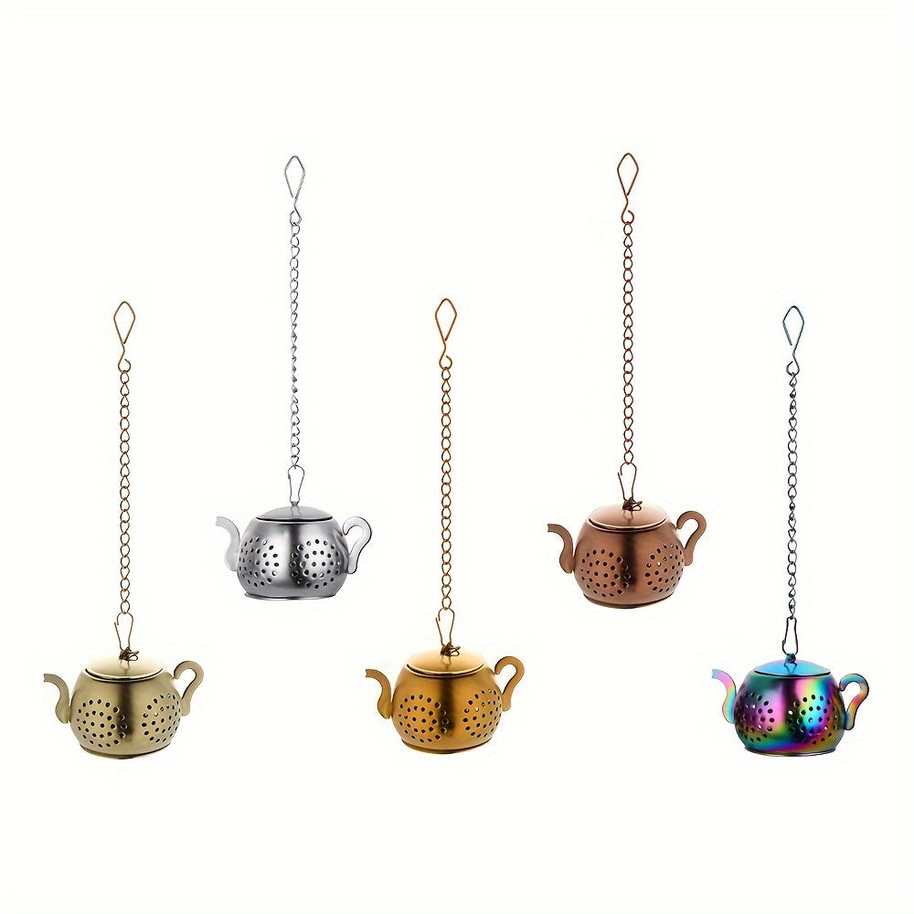 Golden rose stainless steel teapot-shaped tea strainer with uniform filter holes and hanging chain for cups.