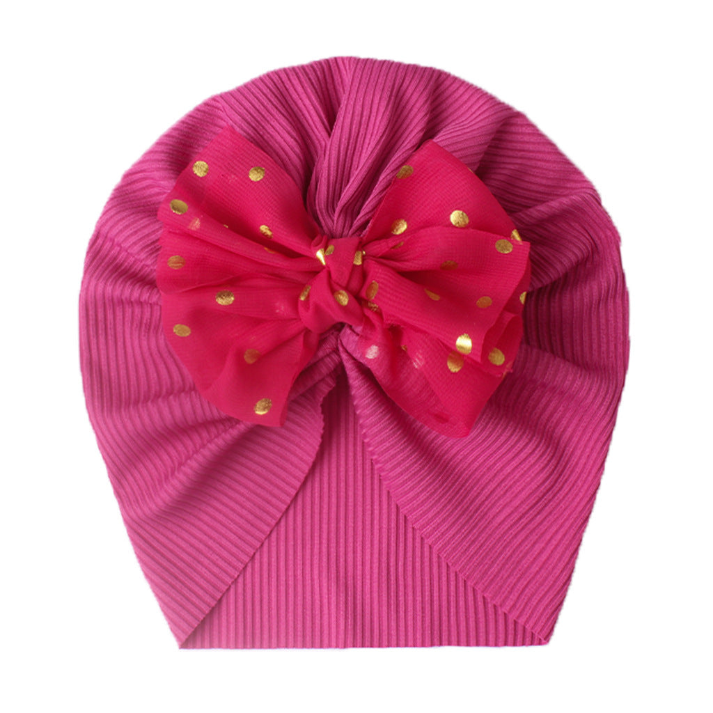 Polka dot printed bow head wrap for newborn infants and toddlers.