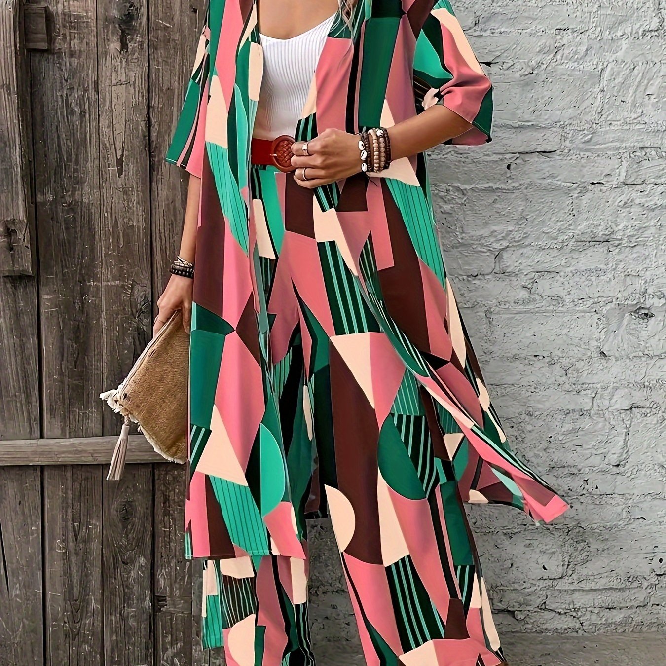 Stylish plus-size geometric print ensemble includes open front shirt, wide-leg pants made of elegant polyester. Perfect for fashion-forward ladies, machine washable.