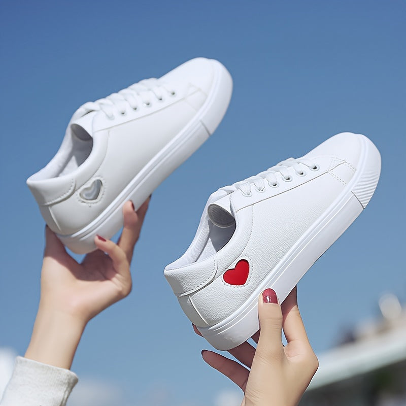 Stylish women's casual sneakers with heart-shaped design, lace-up style, and flat white soles - ideal for leisure wear.