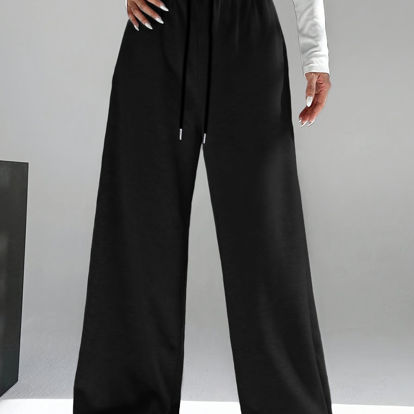 High waist wide leg drawstring pants in contrasting colors for women's spring and fall attire.