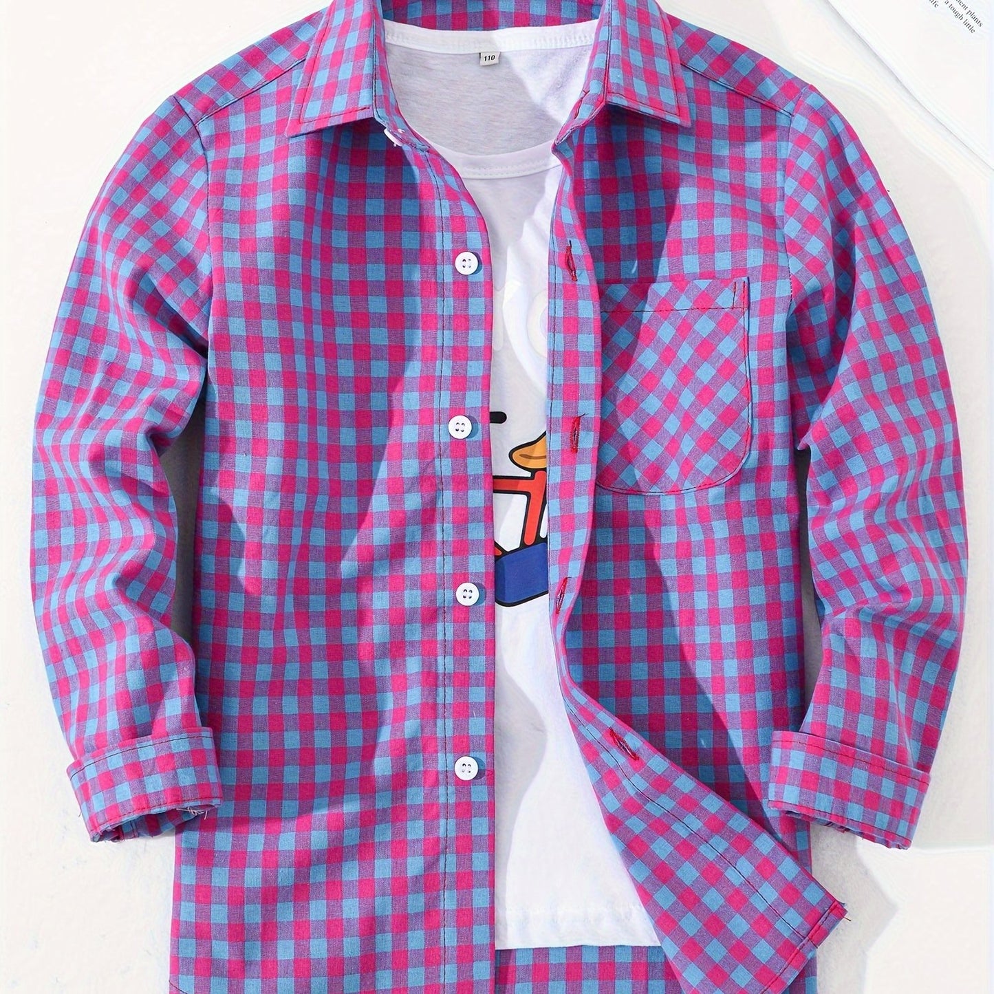 Children's preppy plaid long sleeve shirt made from 100% cotton woven fabric. Features a regular fit with lapel collar and button details. Non-stretch material suitable for boys and girls.