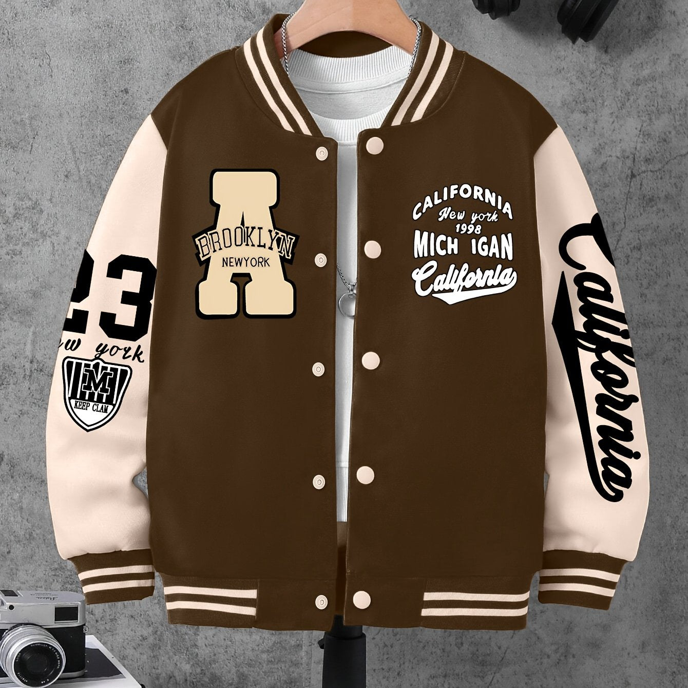 Boys' polyester varsity jacket with geometric pattern and baseball collar, featuring letter A and number 23 print.