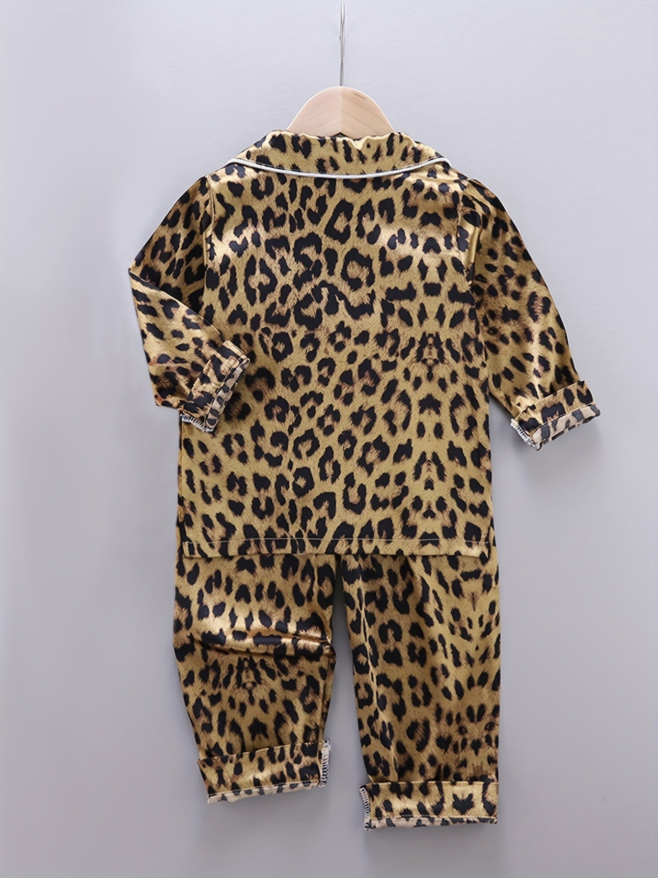 Comfortable leopard print pajamas with front buttons, long sleeves, elastic waistband, and long pants for home wear.