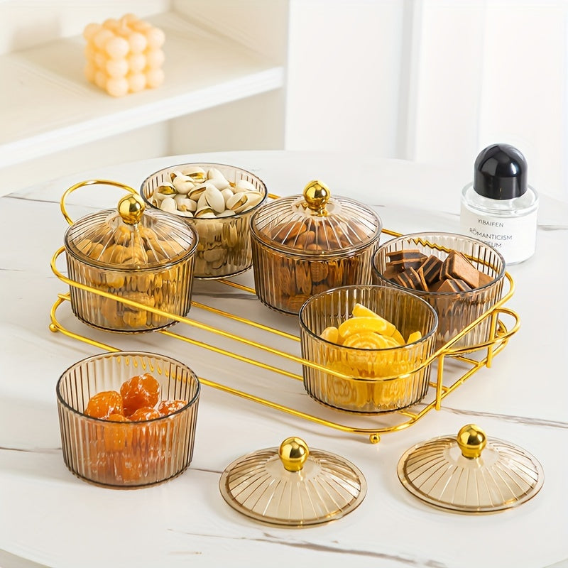 Luxurious snack serving set with lid-covered plastic dishes on a golden tray, perfect for displaying dried fruits and candies on a living room coffee table.