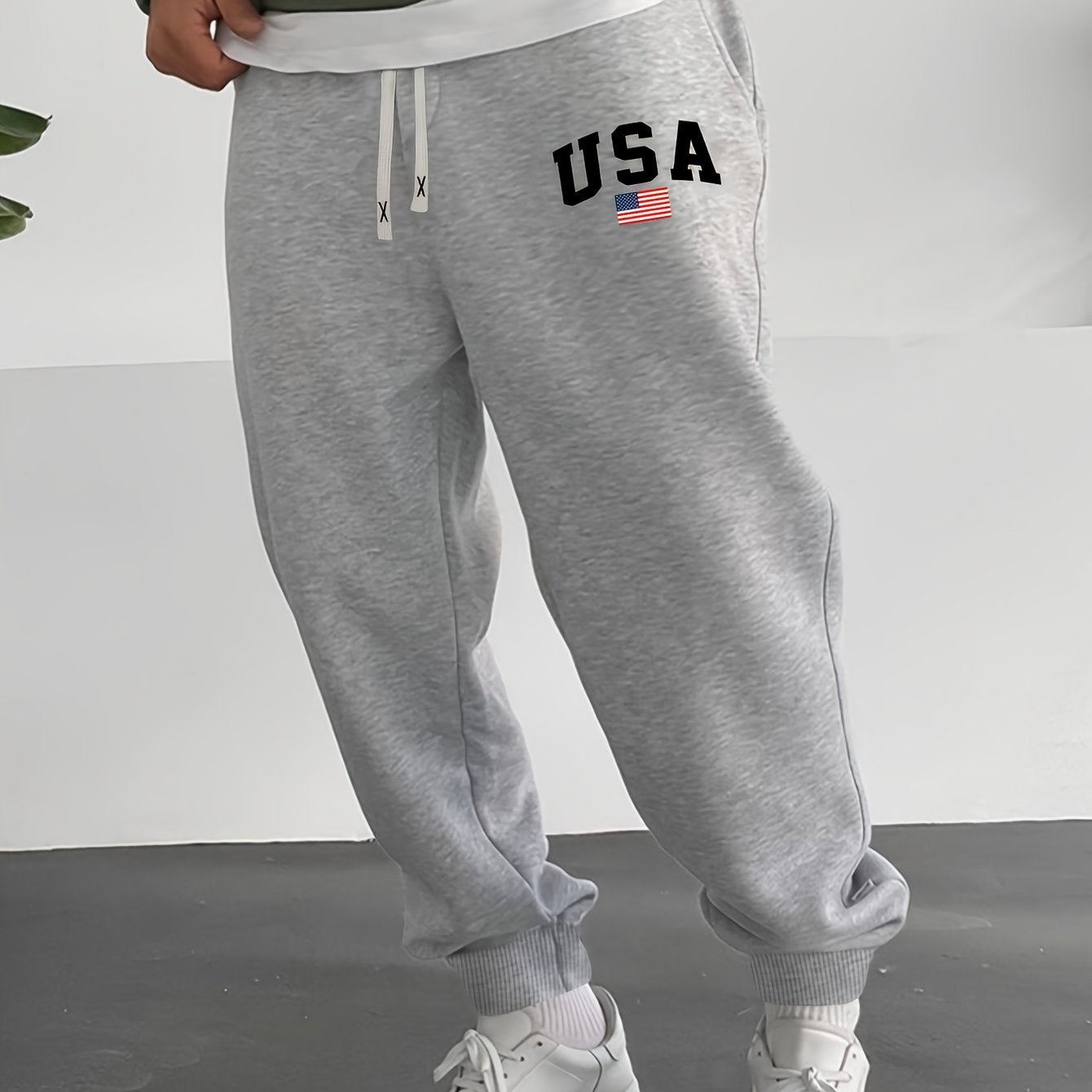 Men's casual knit sweatpants with USA flag print, elastic waist and drawstring for outdoor activities.