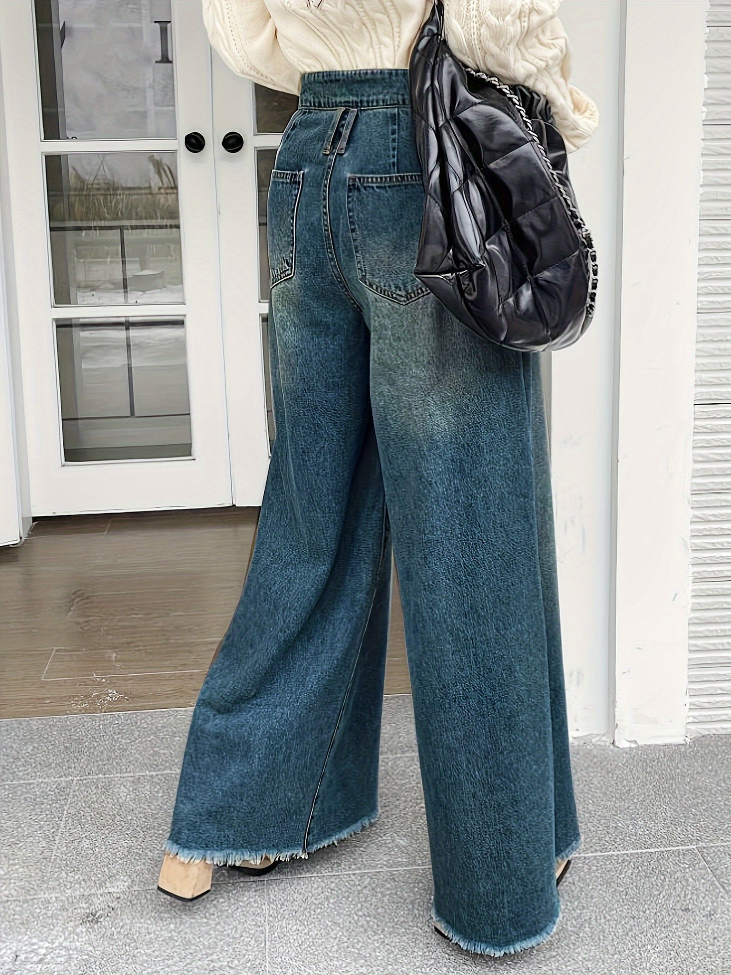 Women's wide-leg denim jeans with elastic waistband, loose fit, mid-rise, and slash pockets in light to dark blue gradient.