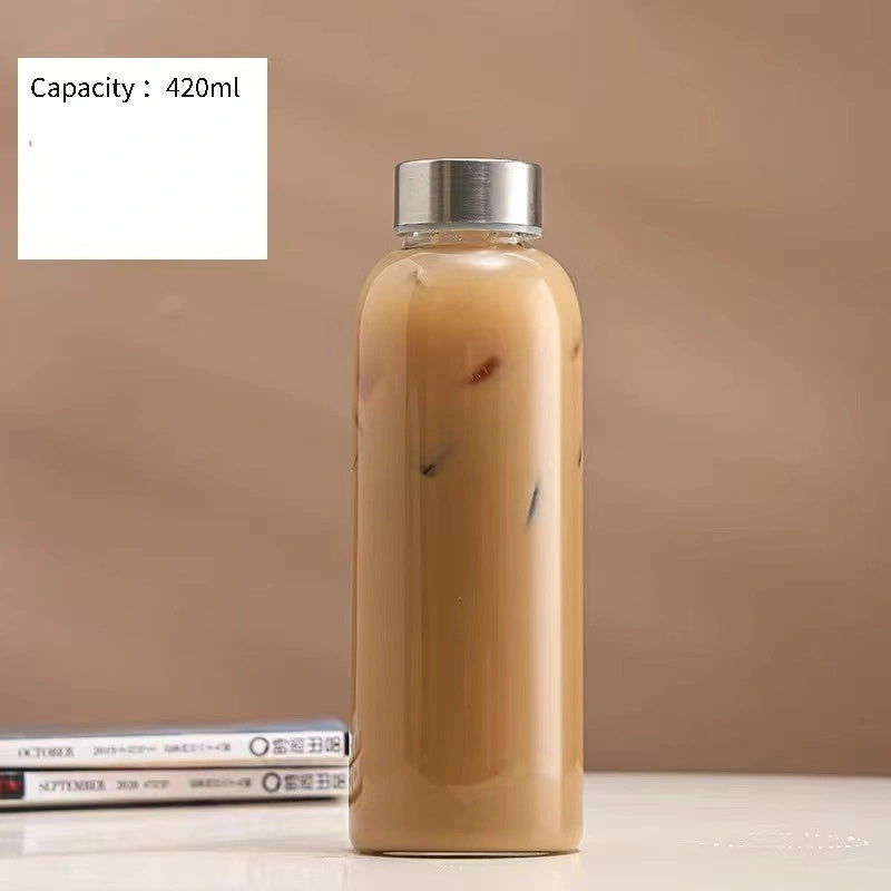 This borosilicate glass bottle comes with both a stainless steel lid and a wooden bamboo lid, making it perfect for travel and storing a variety of beverages such as juice, smoothies, kombucha, kefir, and tea. It is 100% leakproof and can be safely used