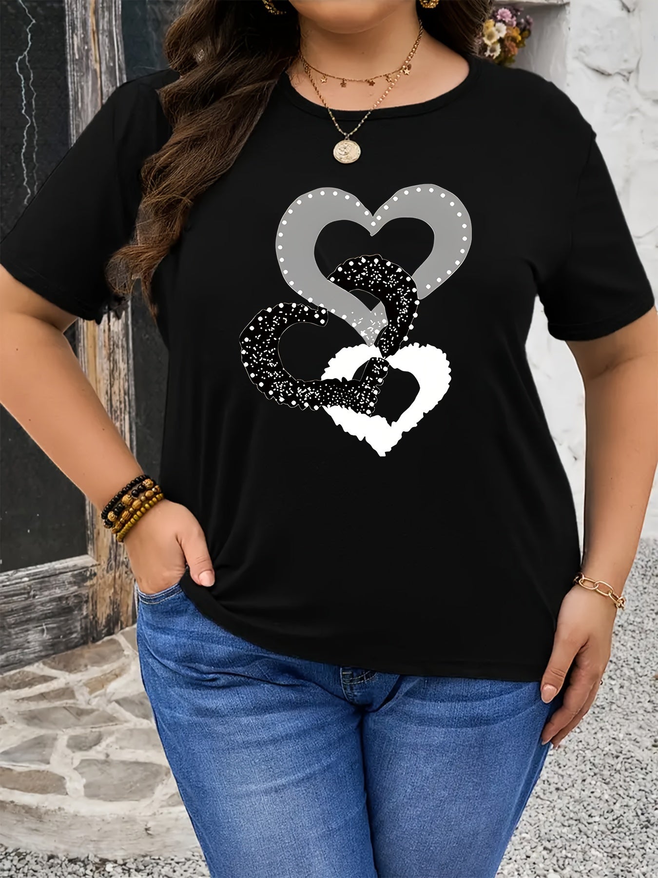 Black heart graphic tee in plus size, soft touch, chic design, crew neck, short sleeve, stretchy polyester blend, machine washable.