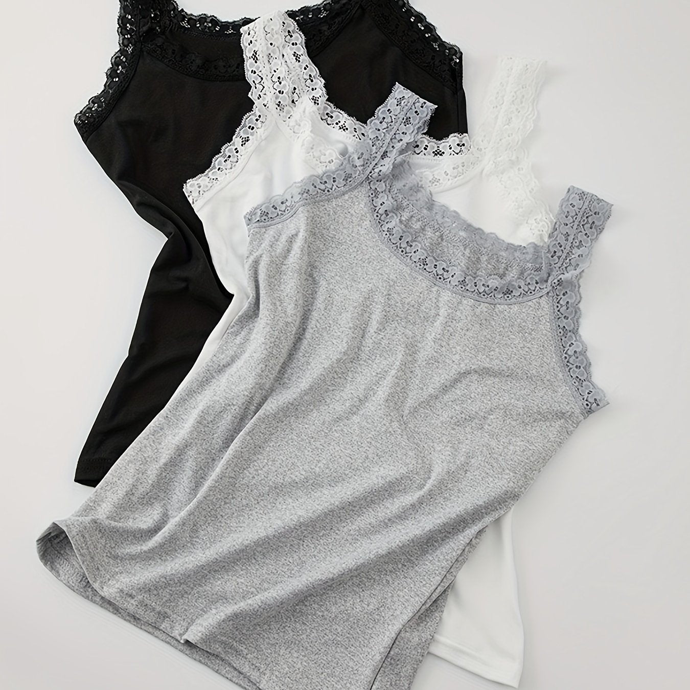 Three solid color lace trim tank tops in black, white, and gray. Versatile round neck design for all seasons. Basic fit and breathable for women's underwear.