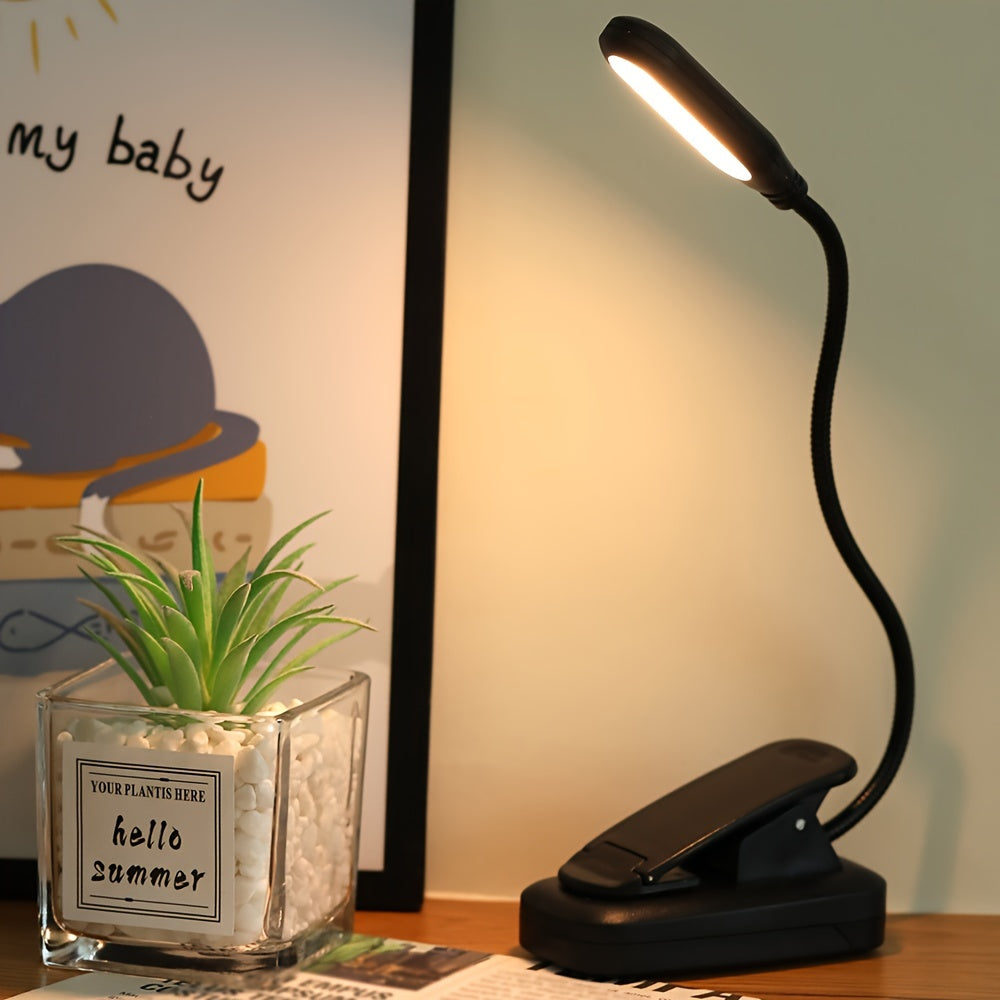 Portable battery-powered space-themed book light with adjustable arm, push button control, and uplight lighting, ideal for bedside use.