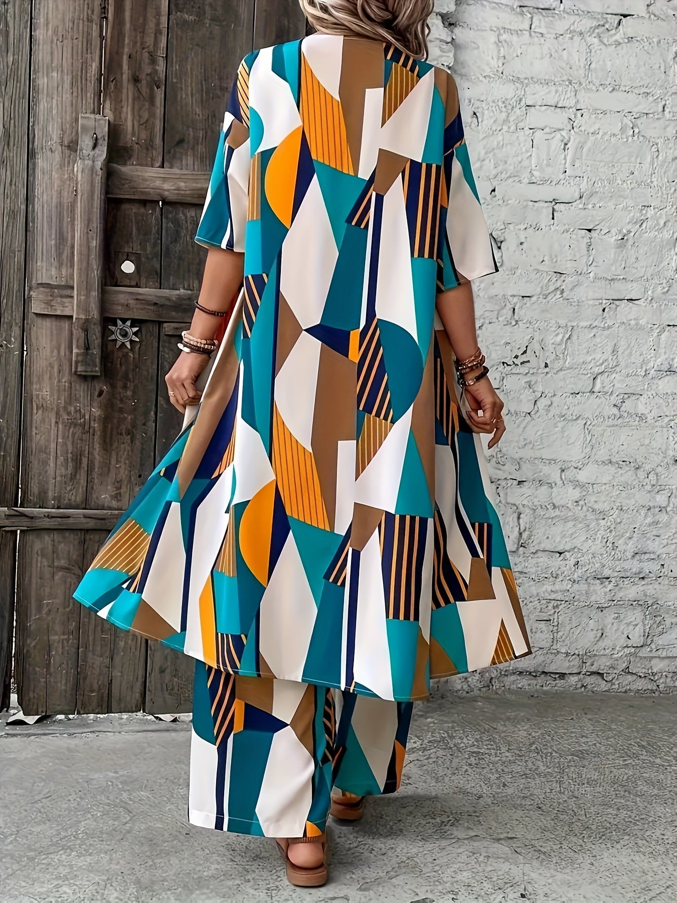 Stylish plus-size geometric print ensemble includes open front shirt, wide-leg pants made of elegant polyester. Perfect for fashion-forward ladies, machine washable.