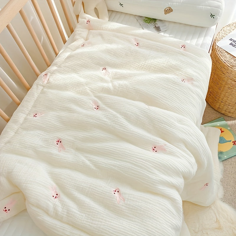 Soft cream-colored quilt with embroidered bear and rabbit, perfect for kids all year round. Made from durable knit fabric for naps and home use.