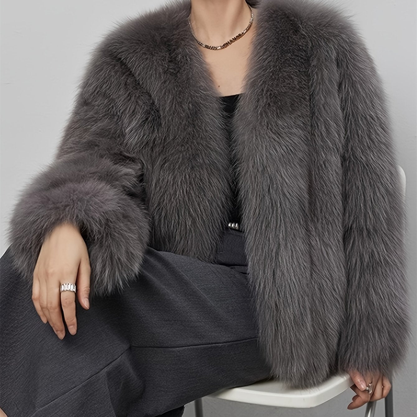 Stylish women's coat in light gray faux fur with fluffy collar, perfect for cold weather