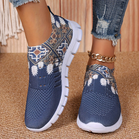 Women's casual slip-on sneakers in blue knit fabric with white floral and geometric patterns, featuring a lightweight EVA sole and breathable low-top design. Perfect for everyday wear with