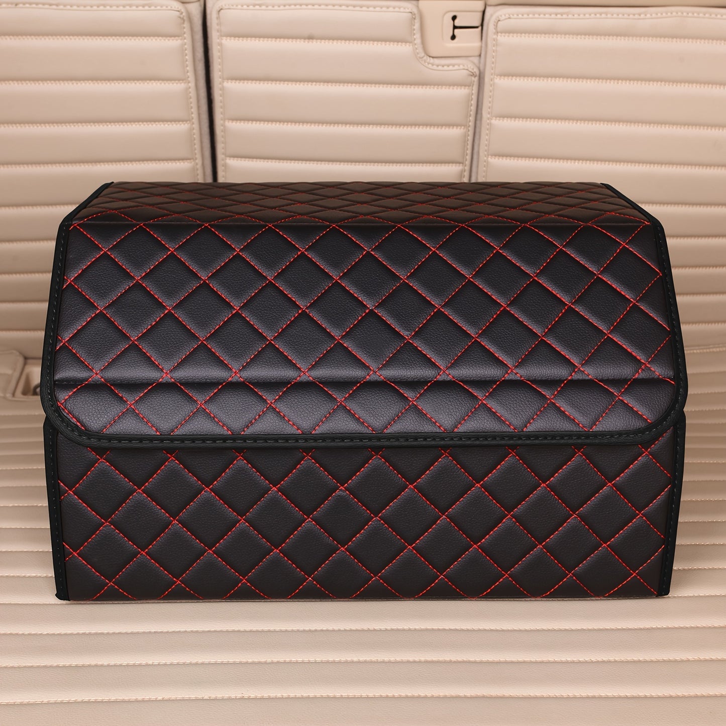 Car trunk organizer made of premium PU leather with diamond stitching and red accents, collapsible and multi-compartment storage box for cars, trucks, and SUVs.