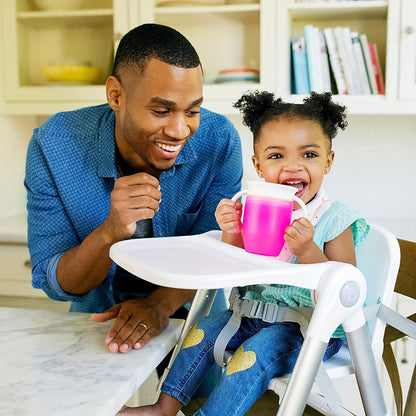 Pink and white leak-proof training cup with easy-grip handles for young children. Made of durable, lightweight silicone and is handwash recommended.