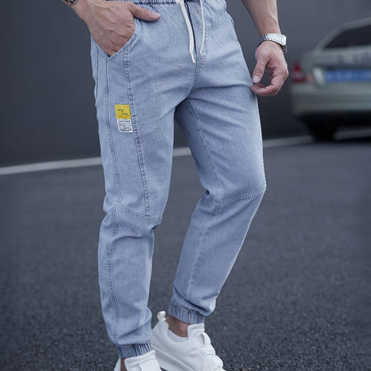 Trendy men's tapered jeans with waist drawstring